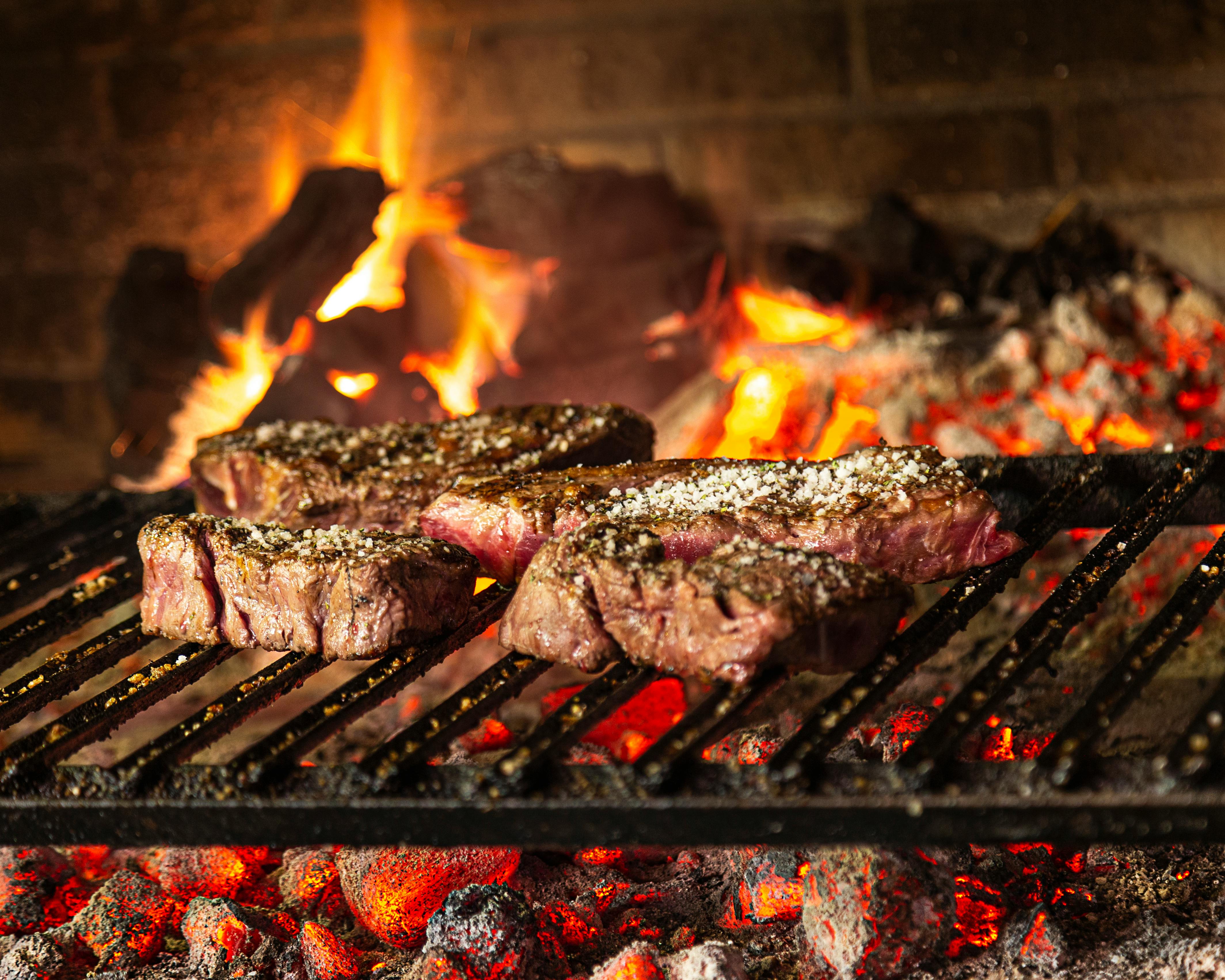 Char-grilled meats over open flame - Fire Que